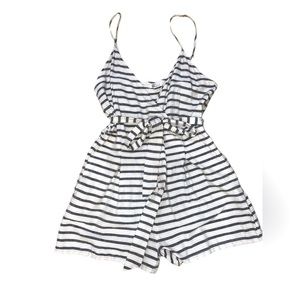 Billabong cream, black and white striped romper. Never worn size medium.